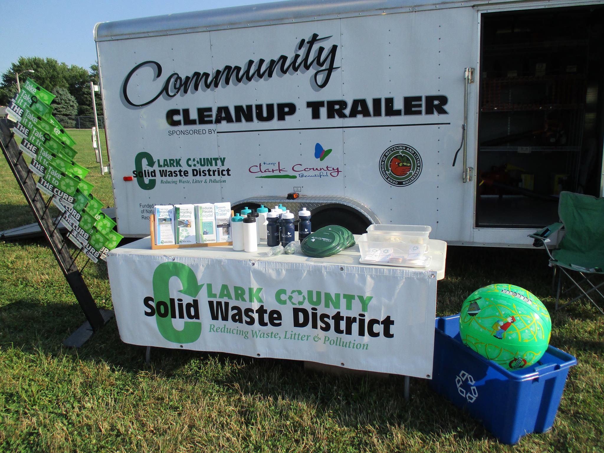 A photo of the Community Cleanup Trailer and other marketing materials.